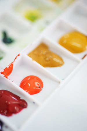 Details of the creative process of the artist, a a watercolor palette with paints. Art education and art. Soft focus and beautiful bokeh.の写真素材