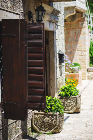 Old stone buildings on narrow streets of medieval towns. Travel to the Balkans and Montenegro. Masonry of ancient buildings. City landscape.の写真素材