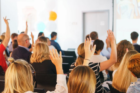 Participants of the conference vote and signal the speaker with their hands up in a special audience...