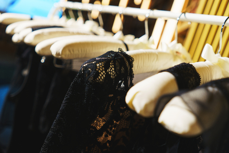 Attractive and seductive lingerie on a hanger in a women's clothing store. Close-up details, lace on a bra and women's lace panties. Sexuality and attractiveness. Sale for the holidays.の写真素材