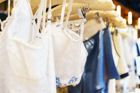 Attractive and seductive lingerie on a hanger in a women's clothing store. Close-up details, lace on a bra and women's lace panties. Sexuality and attractiveness. Sale for the holidays.の写真素材