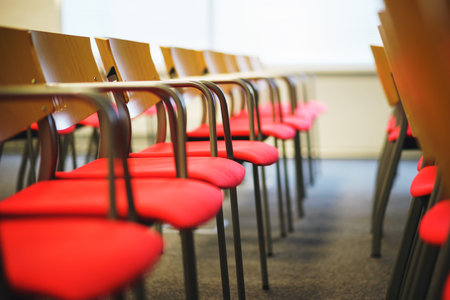 Several rows of empty chairs in the audience prepared for the speaker's speech in front of students...