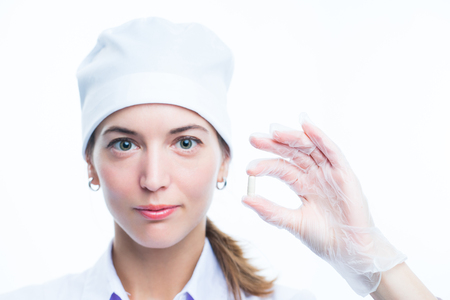 Medic doctor holding pills. Hands and pills close up. Treatment and health care. Pharmacist holds a handful of pills for a patient. Scientific laboratory and medical clinic. Focus on pills.の写真素材