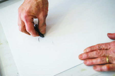 Artist makes the first srihi on canvas in the process of drawing with pastel crayons. Concept of the...
