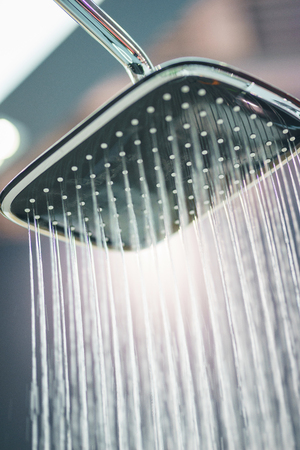 Water pours from the modern shower. Jets of water in the shower close-up. Stylish and luxury plumbing. Water saving and refreshing shower.の素材 [FY310120698170]