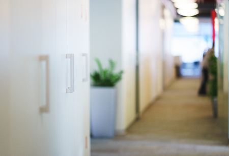 Lockers for documents and personal items in the workspace. Modern office and room design for employees. Glass office partitions and unrecognizable interior. Soft focus and beautiful bokeh.の写真素材