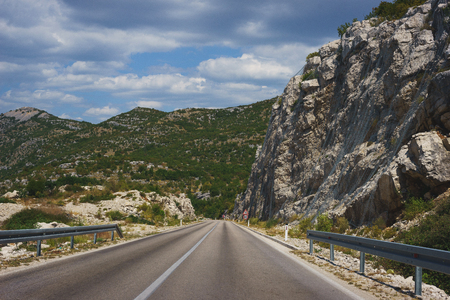 Travel by car. Good asphalt road in the mountains. Trip to Europe, the Mediterranean and the Balkans. Roads and landscapes of Montenegro, mountains and valleys.の写真素材