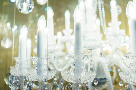 Detail design and interior lighting - white metal lamp in the form of candlesticks and candles....