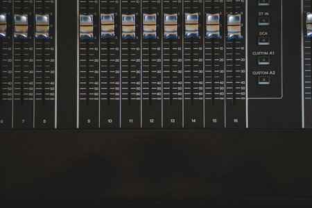 Sound equipment, large mixing console for sound producer. Performance and sound design of events, holidays and parties. Modern technical equipment. Sound amplifier. Soft focus and beautiful bokeh.の写真素材