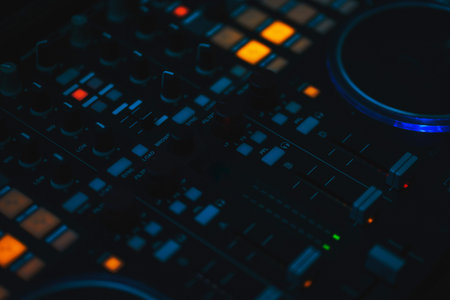 Music equipment controller for DJ. Bright neon lamps and glowing buttons on the sound control in a...