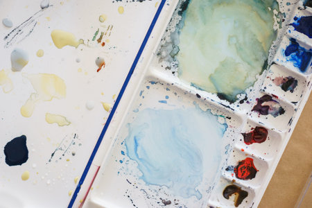 Artist paint brushes and watercolor plastic palette. Instruments and tools for creative leisure....