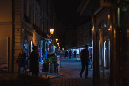 PRAGUE, CZECH REPUBLIC - OCTOBER 2019. Residents and guests of the city on streets to see the sights. Travel to an old European city. Autumn season. Night photography with High sensitivity. Tinted.のeditorial素材