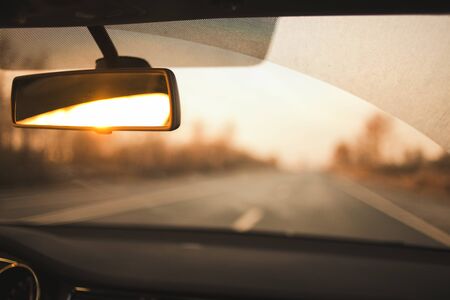 Car trip. View of the road from the car in the early morning. Soft focus, motion blurred image. Autumn. Overcast morning.の写真素材
