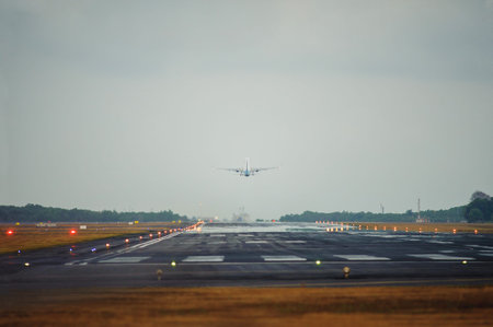 Silhouette of a passenger airliner in the sky during sunset. Airplane and runway. Take-off and...