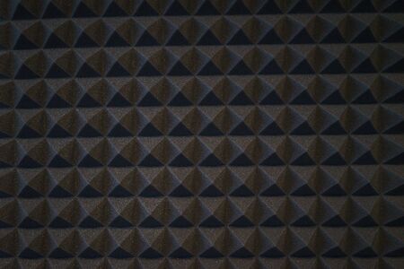 Foam material specifically for the walls of a recording studio. Soundproof and sound absorbing materials. Details, close-up of triangles wall decoration. Soft focus and shallow depth of field.の写真素材