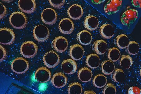 Catering and guest meals during the event. Quick mini snacks in a special beautiful dish. Canapes and light meals, tapas on the table in the restaurant.の写真素材