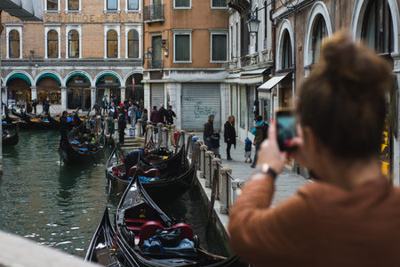VENICE, ITALY - OCTOBER, 2019. Travelers on the narrow historical streets of the ancient city.のeditorial素材