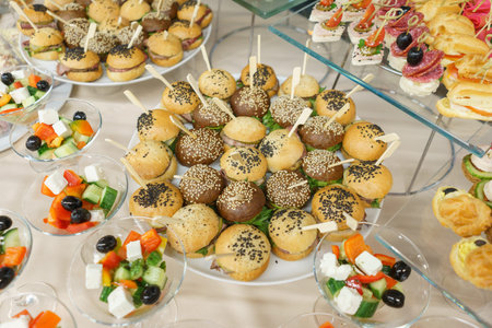 Catering and guest meals during the event. Quick mini snacks in a special beautiful dish. Canapes and light meals, tapas on the table in the restaurant.の写真素材