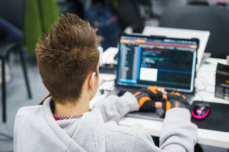 programmer coder working on his laptop. Software development. Programmer coding web application client server. Developer of program code. process of writing code in a special application.の写真素材