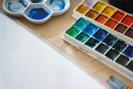 Artist paint brushes and watercolor paintbox on plastic palette.の写真素材