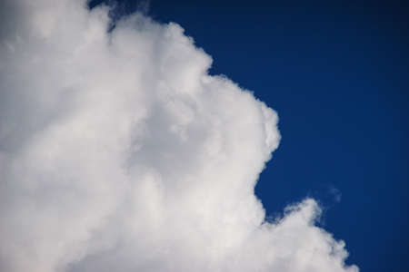 Large white cumulus clouds against a blue sky.の写真素材