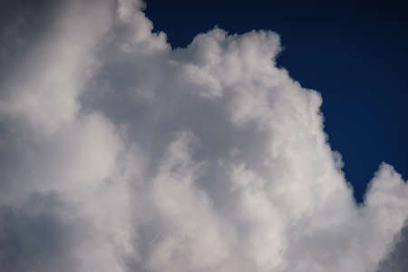 Large white cumulus clouds against a blue sky.の写真素材