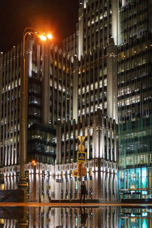 Blurred modern car in motion on the night streets. Low point shooting.の写真素材