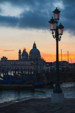 View of the Grand Canal and Basilica di Santa Maria della Salute in Venice during sunset.の写真素材