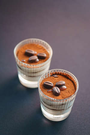 Traditional tiramisu dessert in a glass goblet on the table.の写真素材