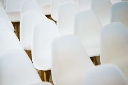 White empty seats in the audience prepared for the participants of the conference or presentation.の写真素材