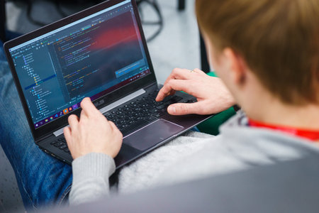 programmer coder working on his laptop. Software development. Programmer coding web application...