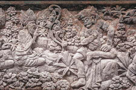 Images of gods and demons carved from stone in sacred temples island of Bali. Decor and decoration of ancient Hindu temples. Monkey Forest, sacred temple complex in Ubud island of Bali, Indonesia.の写真素材