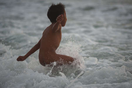 BALI, INDONESIA-MARCH 2020: Indonesian children play on the beach at sunset time. Active, beach holidays in Asian countries. Landscape Bali Thailand. Soft focus. Lots of tourists on the beach.のeditorial素材