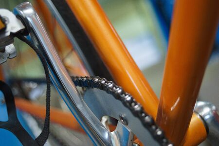 Workshop on maintenance and repair of bicycles. Details, close-ups, bicycle maintenance process. Handicraft workshop. Tools, workbench and bike rack. Soft focus and beautiful bokeh. Details close-up.の写真素材