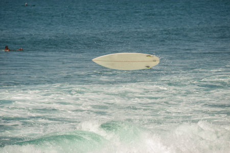 BALI, INDONESIA-MARCH 2020: Young people ride on short boards, perform tricks on the waves. Extreme...