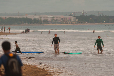 BALI, INDONESIA-MARCH 2020: Young people ride on short boards, perform tricks on the waves. Extreme...