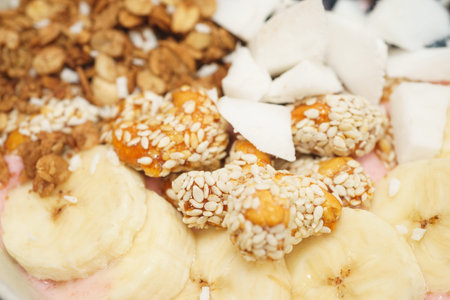 Extreme close-up handmade Bowl with healthy tasty breakfast of yogurt, smoothie with granola, nuts,...