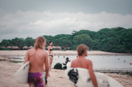 Balinese landscape sandy beach, ocean waves and tropical palm trees, shore. Beach holidays on a...