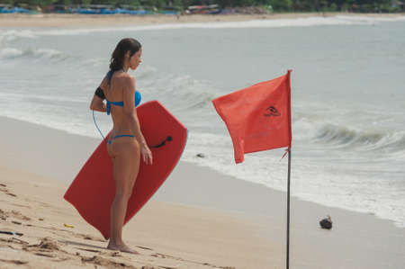 KUTA, INDONESIA - SPRING, 2020: Active vacation on the beach Semenyak, Jimbaran. Beach holidays and entertainment at sea, tourists and residents relax on the beach. Travel to Asia.のeditorial素材