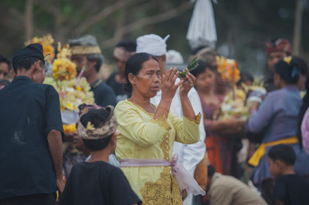 BALI, INDONESIA-APRIL, 2020: Traditional Balinese blessing ceremony by ocean elder, shaman, monk or...