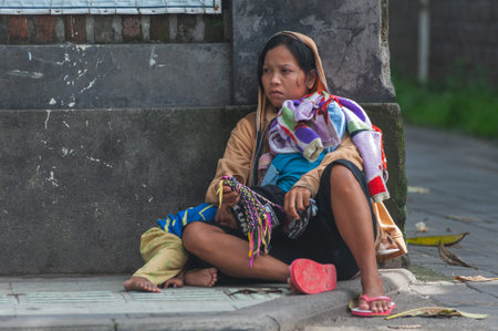 KUTA, BALI, INDONESIA-APRIL, 2020: Indonesians locals and street market employees sell souvenirs,...