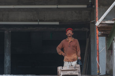 KUTA, BALI, INDONESIA-APRIL, 2020: Indonesians builders during the construction of the building. Working conditions, poverty and the environment in Asia. Society and modern life. Travel to Asia.のeditorial素材