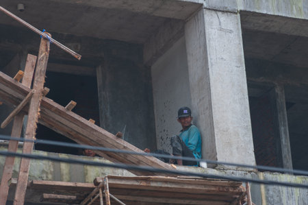 KUTA, BALI, INDONESIA-APRIL, 2020: Indonesians builders during the construction of the building....