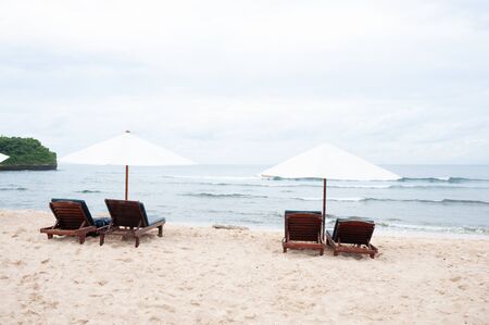 Tropical landscape: sunbeds and parasols on the beachの写真素材