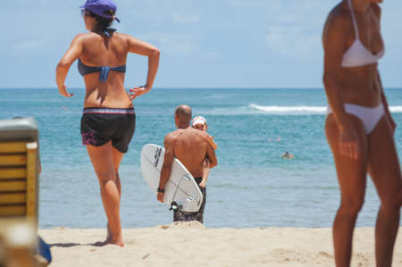 NUSA DUA, BALI, INDONESIA-SPRING, 2020: Vacationing young people are sunbathing Nusa Dua sandy beach. Travel and beach holidays on a tropical island. Families children and people.のeditorial素材