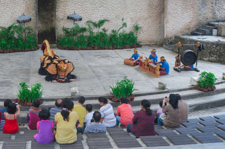 BALI-APRIL, 2020: Garuda Wisnu Kencana Cultural Park on island Bali. Traditional Balinese dance Kechak, dancers tell a story, dancing with eyes, fingers and limbs. Performance on stage.のeditorial素材