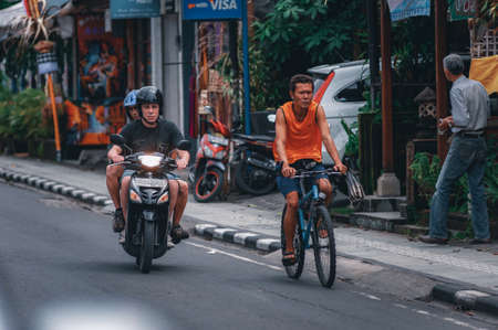 KUTA, INDONESIA-SPRING, 2020: Busy traffic on the island of Bali. Tourists and residents of the island on mopeds and cars. Traffic jams. Air pollution. Travel to Asia.のeditorial素材