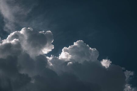 Large white storm cumulus clouds against a blue sky. Closeup of clouds in the sky. Nature backgroound.の写真素材