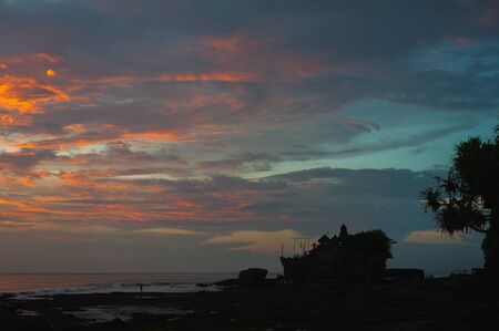 Sacred temple of Tanah Lot on a stone rock in the ocean.の写真素材