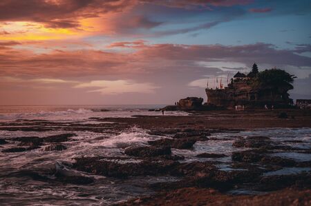 Sacred temple of Tanah Lot on a stone rock in the ocean.の写真素材